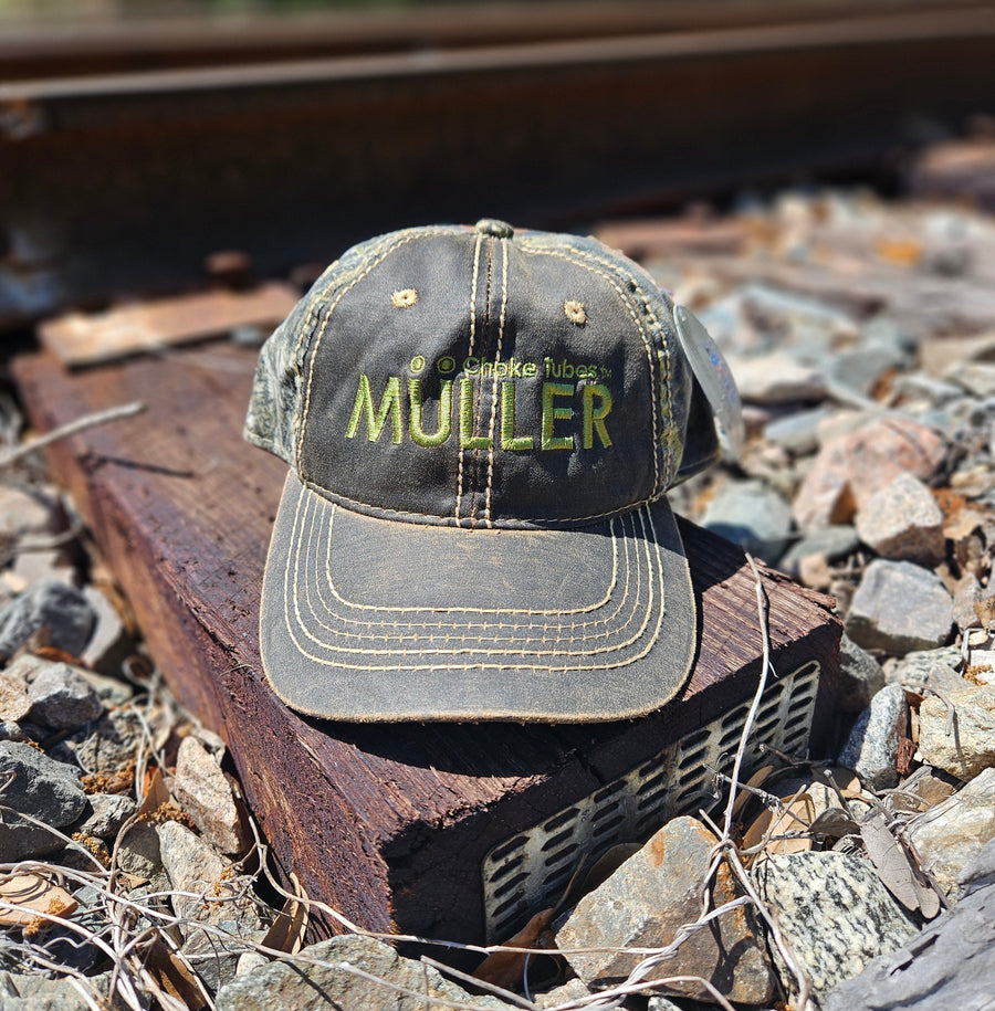 *CAP* Brown Muller Chokes Hunting Cap. Front: Yellow-Green Logo, Back: Mossy Oak New Break Up Camo