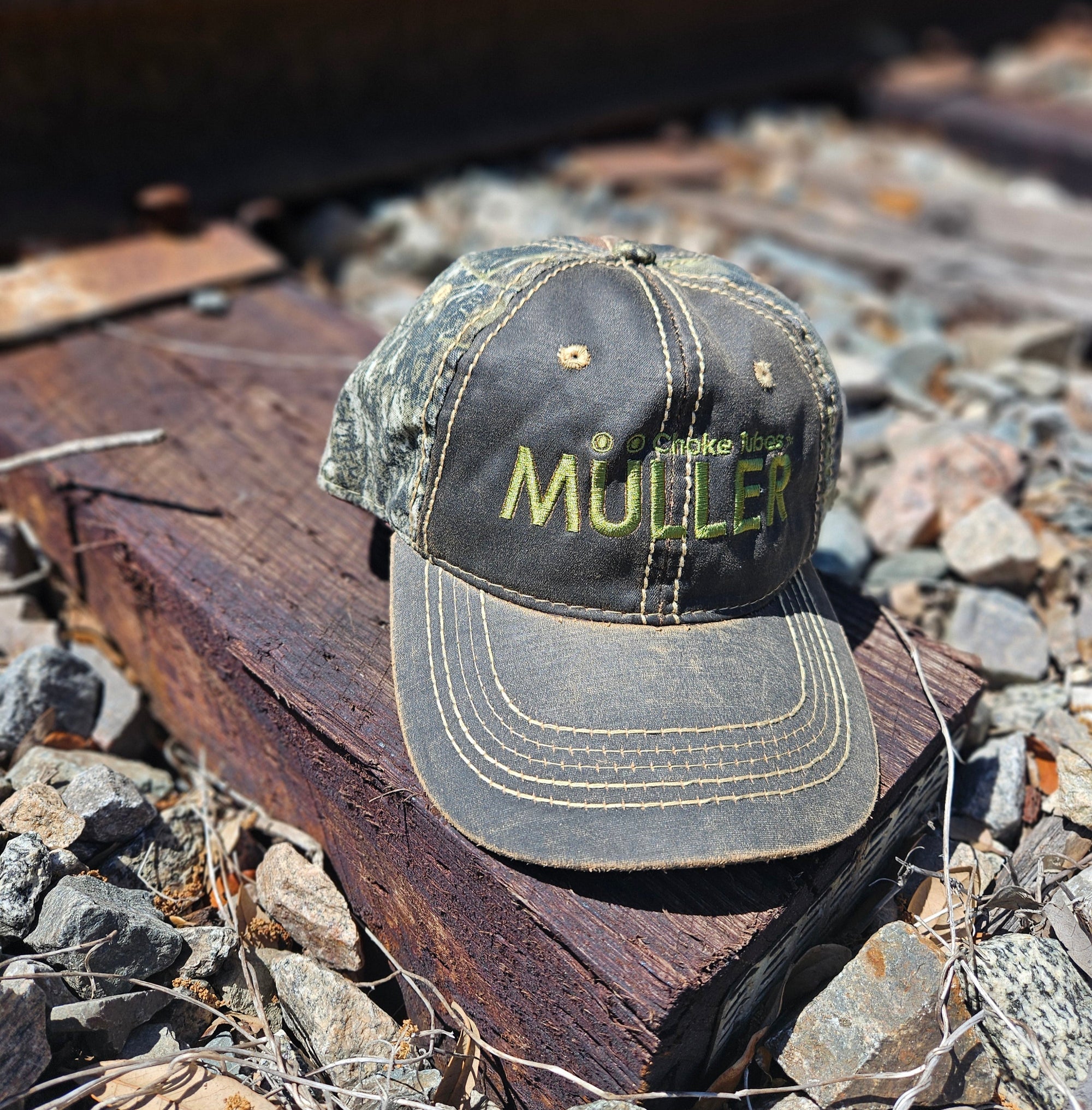 *CAP* Brown Muller Chokes Hunting Cap. Front: Yellow-Green Logo, Back: Mossy Oak New Break Up Camo