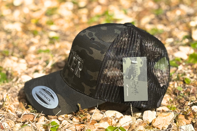 *CAP* MC LOGO BLACK CAMO Muller Chokes Hunting Cap. Front: Black Camo, Back: Black Trucker Mesh