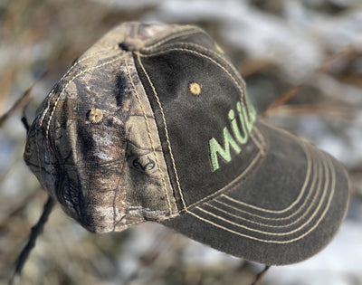 *CAP* Brown Muller Chokes Hunting Cap. Front: Olive Green Logo, Back: Realtree Camo