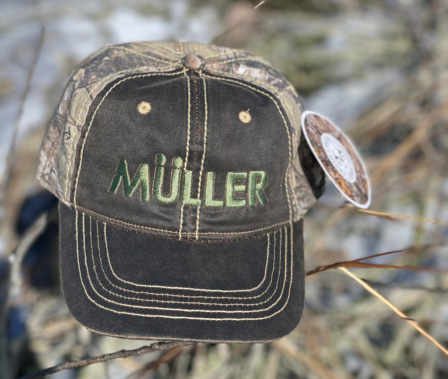 *CAP* Brown Muller Chokes Hunting Cap. Front: Olive Green Logo, Back: REALTREE XTRA Camo